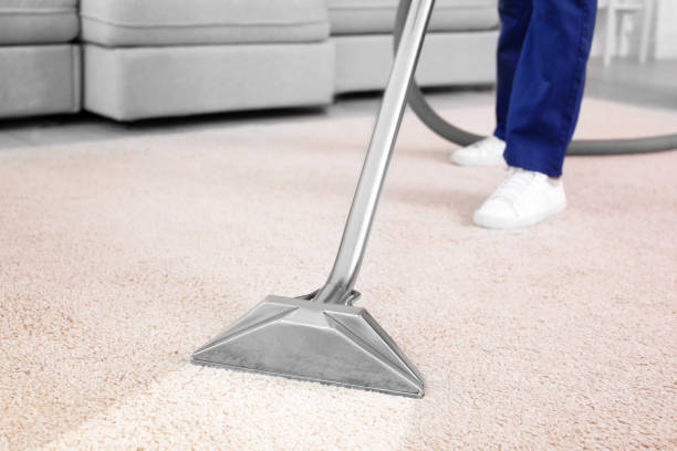in this picture the vaccum is cleaning the durst from the carpet